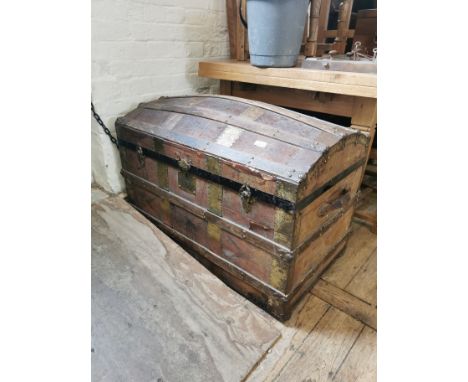 A vintage canvas and metal bound traveling trunk 
