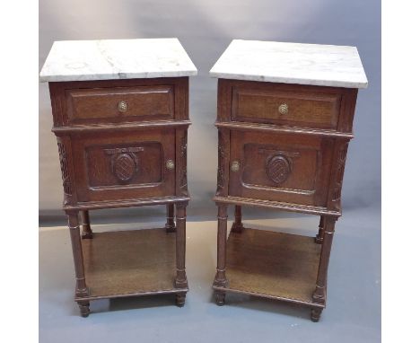 A pair of early 20th Century French oak lamp tables with marble tops above drawer and cupboard door. H-85cm 