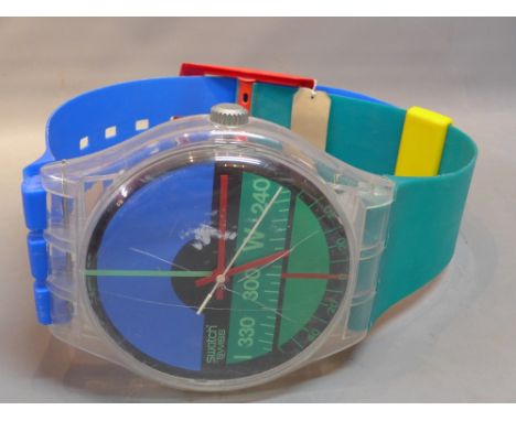 A Swatch wall clock in the from of a wrist watch, dated 1987