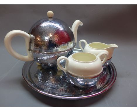 An Art Deco tea service to include cream jug sugar bowl, teapot and tray