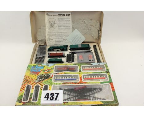 A Pair of 'Cheap and Cheerful' train sets: comprising a Lima 'Crick' set with red clockwork Diesel loco (one wheel missing), 