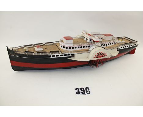 A large vintage Tinplate model of a  Paddle Steamer, built and painted to an amateur standard, lacks motor and funnel, 34'' l