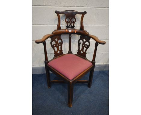 A GEORGIAN MAHOGANY CHIPPENDALE STYLE CORNER CHAIR, with a raised back, drop in seat pad, on square legs united by a cross st