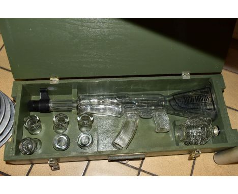 A WOODEN BOXED GLASS RED ARMY VODKA BOTTLE IN THE FORM OF A MACHINE GUN, the case also fitted with a set of six Red Army shot
