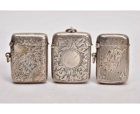 THREE SILVER VESTAS, the first with an engine turned design and floral detailing,  engraved cartouche, fitted with a suspensi