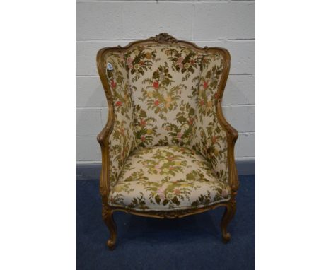 A LOUIS XV STYLE WING BACK ARMCHAIR with a rounded back, width 74cm x depth 71cm x height 111cm (this does not comply with th