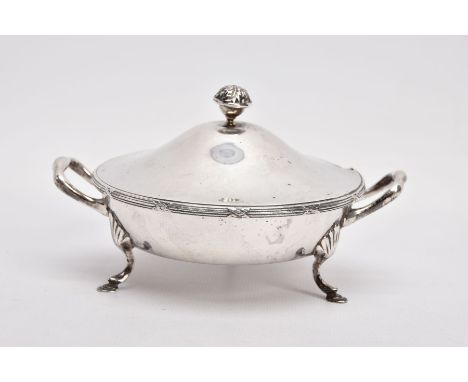 A SILVER AND GLASS CONDIMENT DISH, round form fitted with double handles, raised on three hoof feet, together with cover fitt