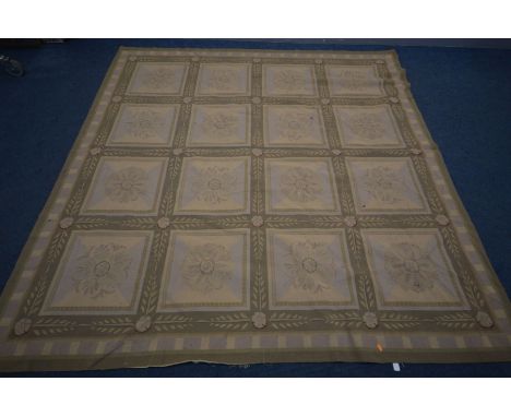 A GREEN PATTERNED WOOLLEN RUG, 240cm squared (the item in this lot is the remanence of a fire damaged property)