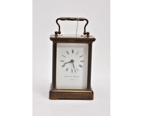 A 'MATTHEW NORMAN' OF LONDON BRASS CARRIAGE CLOCK, white dial signed 'Matthew Norman, London', measuring approximately 11cm h