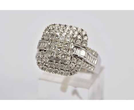 A DIAMOND CLUSTER RING, designed as a central rectangular panel of twelve princess cut diamonds, within a baguette cut surrou