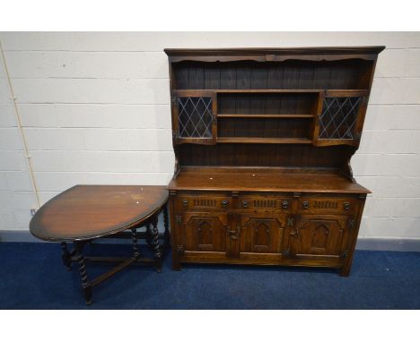 A REPRODUCTION OAK OLD CHARM STYLE DRESSER, two lead glazed cupboard doors flanking two shelves, the base with three drawers 