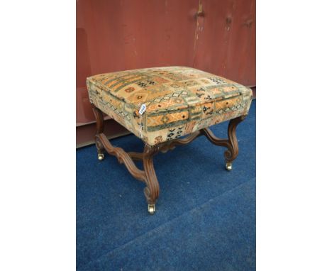 AN EARLY 20TH CENTURY OAK STOOL, on a wavy frame, and later brass casters, width 62cm x depth 56cm x height 50cm (the item in