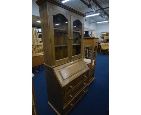 A PINE BUREAU/BOOKCASE, with a fitted interior and three exterior drawers, width 98cm x depth 50cm x height 202cm x height of