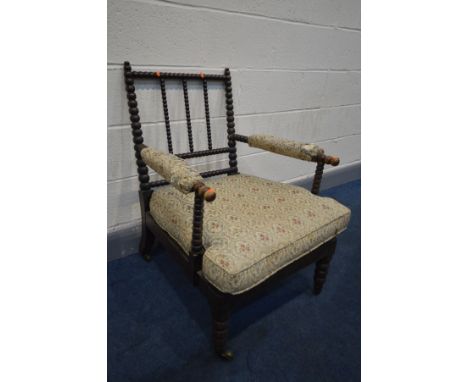 AN EARLY 19TH CENTURY EBONISED BEECH BOBBIN TURNED ARMCHAIR, with open armrests, width 59cm x depth 74cm x height 85cm (condi