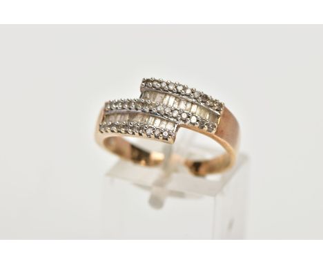 A 9CT GOLD DIAMOND DRESS RING, of a crossover design set with two rows of tapered cut diamonds, between rows of single cut di