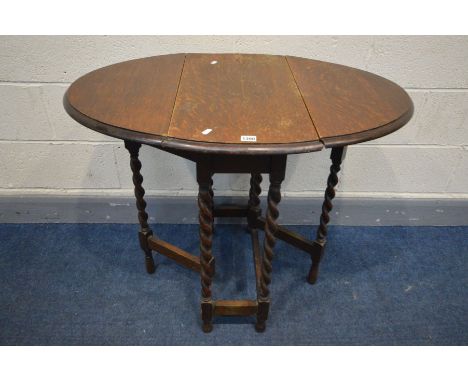 A SMALL OAK BARLEY TWIST OVAL GATE LEG TABLE, length 91cm x closed width 36cm x depth 62cm x height 74cm