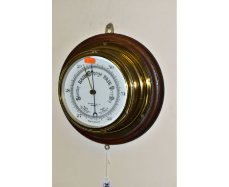 AN EARLY 20TH CENTURY OAK MOUNTED ANEROID BAROMETER, the white ceramic dial printed with John Barker &amp; Co, Kensington and