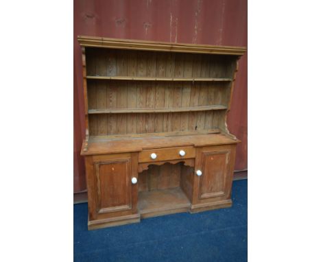 A VICTORIAN PINE DRESSER, with a later top, width 168cm x depth 43cm x height 182cm (the item in this lot is the remanence of
