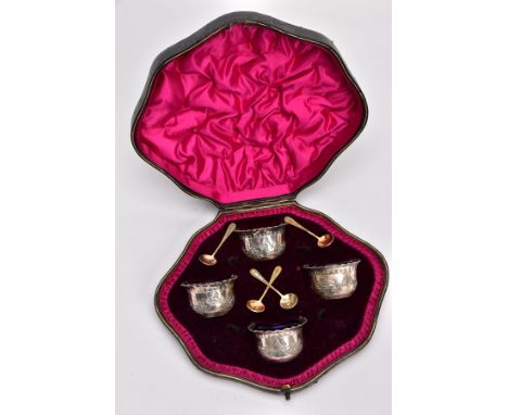 A CASED SET OF FOUR LATE VICTORIAN SILVER SALTS, each with embossed swag floral decoration and scalloped edging, each with bl
