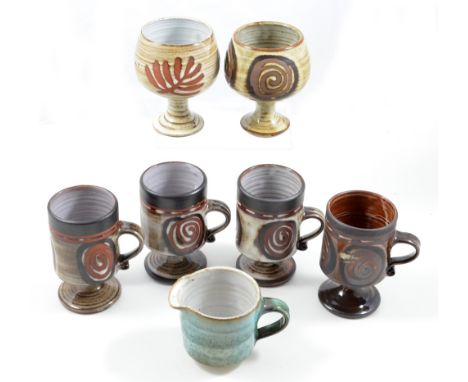 BRIGLIN POTTERY; four earthenware stemmed mugs, two goblets and a milk jug, impressed pottery marks, mug height 11.5cm (7).  