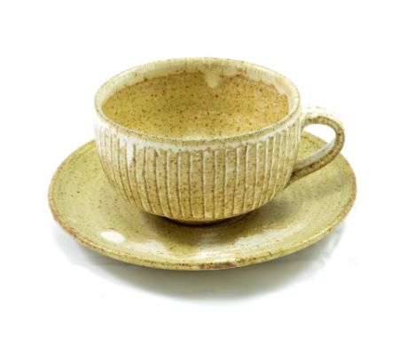 LOWERDOWN POTTERY; a fluted stoneware cup and saucer, impressed L+ mark, cup height 6.5cm. Precision of the fluting suggests 