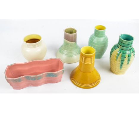 BRETBY; a group of six pieces of Art Deco ware including two similar ribbed vases, a cream ground vase, a pink ground planter