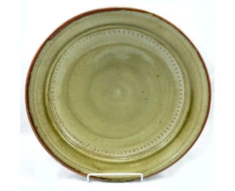RICHARD BATTERHAM (born 1936); a large stoneware dish covered in green ash glaze, diameter 40cm. (D)   CONDITION REPORT:  App