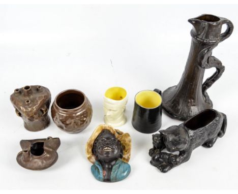 BRETBY; a group of wares including a wall mask modelled as a black boy wearing a hat, a cat planter, a commemorative cup, lar
