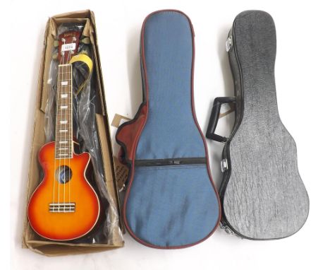 Contemporary Mahalo ukulele, with guitar shaped body and sunburst finish, boxed as new; also a good soprano ukulele case and 