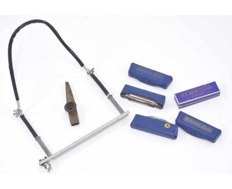 Four Hohner blues harp harmonicas; together with a Hohner Echo Super Vamper harmonica, a harmonica neck brace and a kazoo 