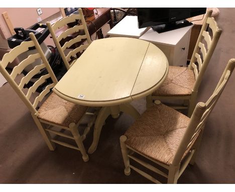 Drop leaf painted pine table with four rush-seated ladder back chairs