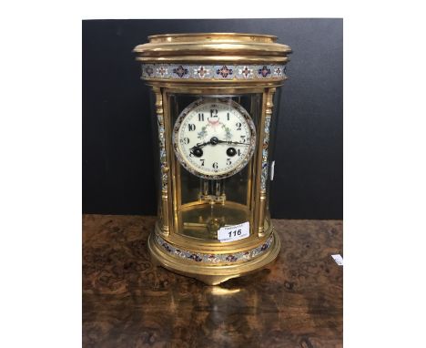 EARLY 20THC FRENCH OVAL GILT & CHAMPLEVÉ ENAMEL CLOCK WITH 4 PANELS OF BEVELLED GLASS & HAND PAINTED FLORAL GARLAND ON THE DI