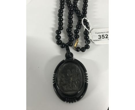 ANTIQUE JET INTAGLIO PEDANT ON JET BEAD NECKLACE, DEPICTING THE GOD MERCURY VENUS