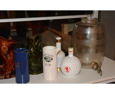 A vintage glass whisky dispenser, of barrel form with lid and tap spout, 39cm high, together with two ceramic gurgle jugs, tw