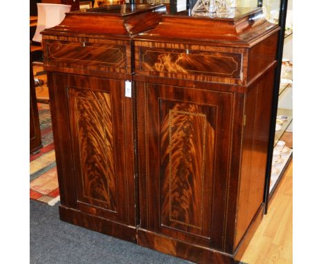 A pair of late George III flame mahogany and inlaid column cabinets, each with tapering moulded rectangular tops, over frieze