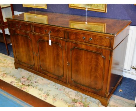 A George III style mahogany dresser sideboard, the crossbanded moulded rectangular top over three beaded short drawers with p