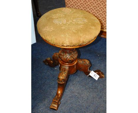 A Victorian mahogany adjustable piano stool, with cushioned seat, raised on acanthus carved column cabriole legs, stamped J. 