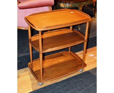 An Ercol what not, with three tiers and tapering turned uprights on casters, 71cm wide x 77cm high x 47cm deep