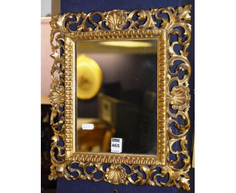 A gilt framed wall mirror, of rectangular form with shelf and foliate decoration, 39cm wide x 34cm high