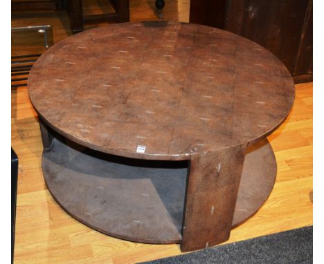 A contemporary coffee table, the whole covered in faux shagreen, with circular top, on supports, united by shelf, 100 cm diam