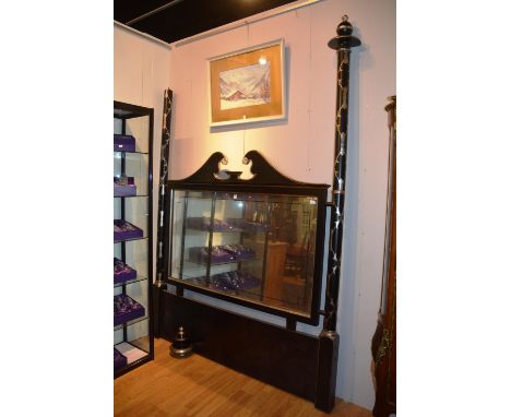 A contemporary mirrored head board, the swan neck pediment over moulded frame, mirrored panel, flanked by foliate column moun