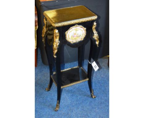 A French ebonised work box, the rectangular hinged top with ormolu moulding over serve style plaque, with floral mounts raise