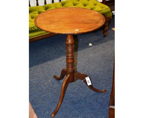 A 19th Century mahogany pedestal table, the lipped circular top raised on baluster turned column and tripod cabriole legs, te