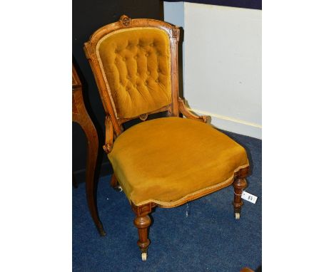 A Victorian walnut lady's parlour chair, the arched button back over serpentine stuff over seat, raised on fluted baluster tu