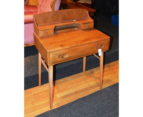 An Ercol blond writing desk with gallery, with one rectangular top frieze drawer, raised on square tapering legs, 69cm wide x