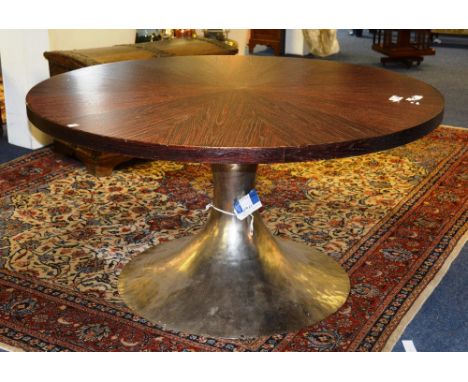 A contemporary kitchen table, the circular top raised on flared beaten metal column, 148cm diameter x 75cm high