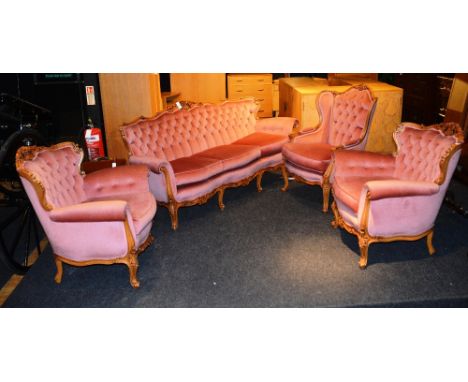 A French style parlour suite, comprising of sofa, three arm chairs, each with foliate carved top-rail, button back loose cush