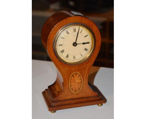 An Edwardian mahogany and inlaid mantle clock, with circular face, Roman numerals, star inlaid trunk raised on plinth base an