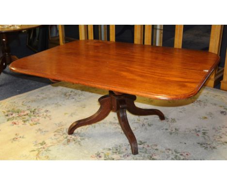 A Victorian mahogany supper table, the moulded rectangular tilt top raised on baluster column, with quad downswept legs, 152c