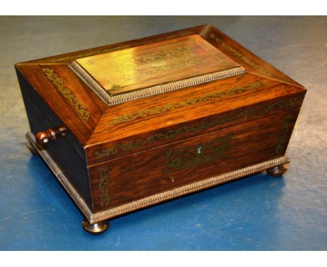 A 19th century rosewood and brass inlaid workbox, the beaded rectangular lid enclosing fitted interior, with tapering trunk a